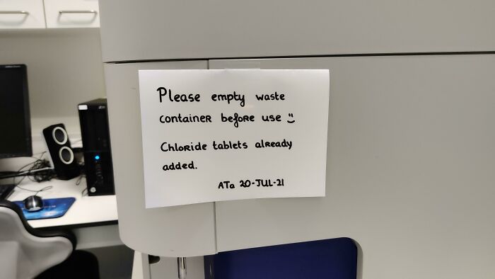 Passive-aggressive note on office equipment reminding coworkers to empty waste container and update tablets.