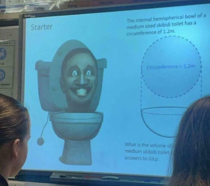 Classroom projector showing a humorous math problem with a cartoon face inside a toilet for funny teachers.
