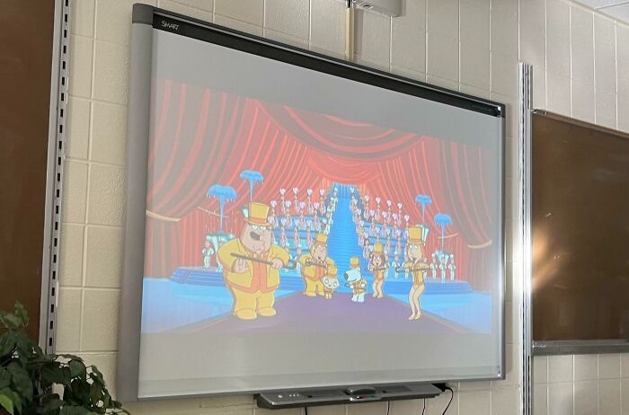 Cartoon playing on a classroom SMART board, showcasing funny teachers with a playful and humorous sense of humor.