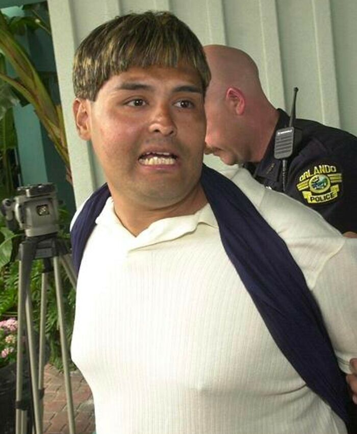 Man being arrested by Orlando police officer, portraying a scene related to famous fraud cases and shocking crimes.