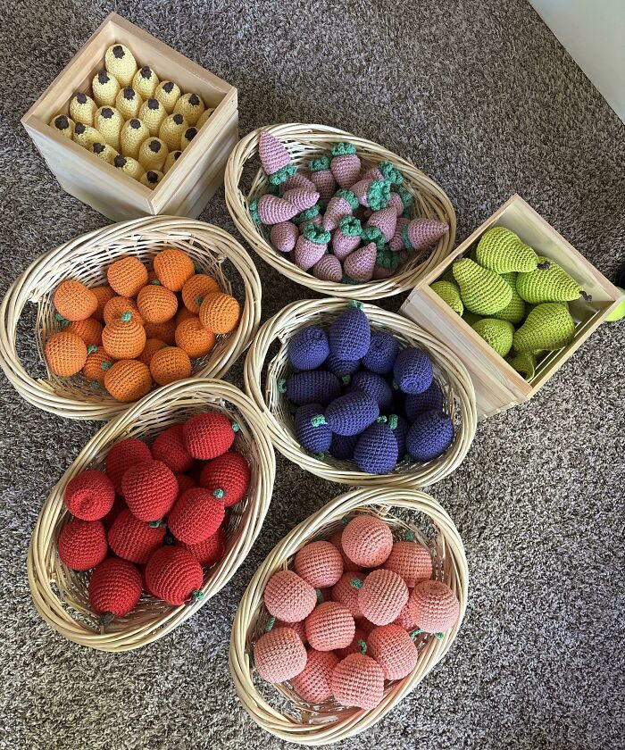 Baskets and boxes filled with colorful crocheted fruit projects showcasing the art of crocheting mastery.