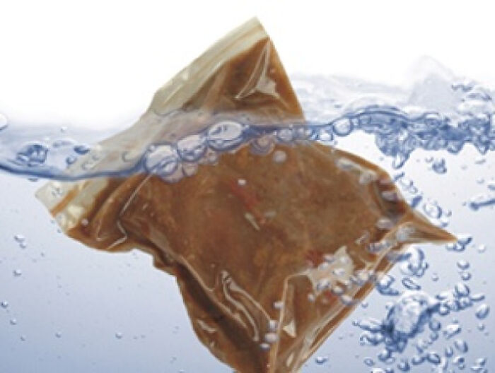 Tea bag submerged in water with bubbles, illustrating a nostalgic image to make you feel old as heck.