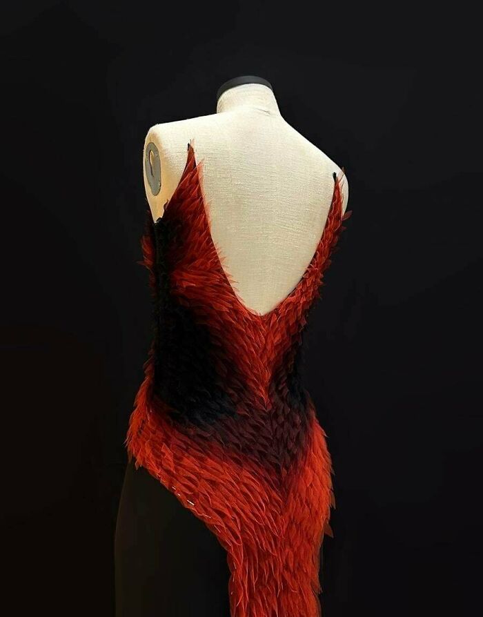 A stunning embroidery creation of a red and black dress on a mannequin, showcasing unique embroidery creations.