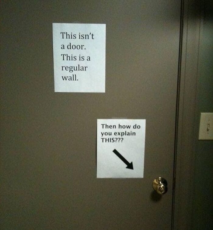 Passive-aggressive notes on a gray door, with humorous messages pointing to a door handle in an office setting.