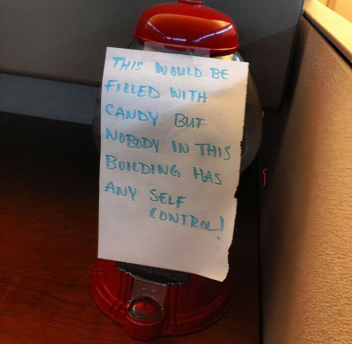 Passive-aggressive note on candy dispenser humorously addressing lack of self control in coworkers at office.