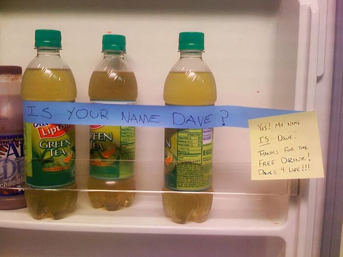 Bottles of green tea with passive-aggressive coworker notes about the name Dave in a refrigerator shelf.