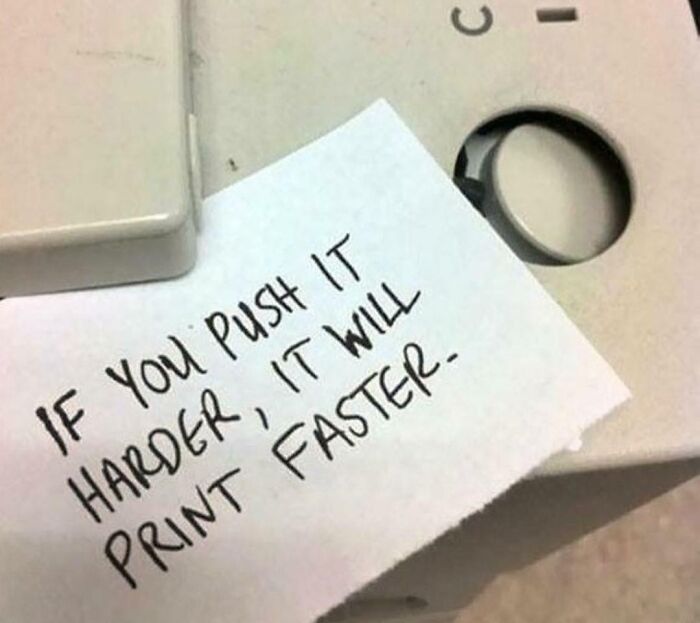 Passive-aggressive coworker note on a printer saying pushing harder will make it print faster.