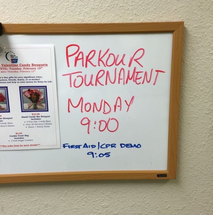Whiteboard with passive-aggressive coworker notes about a parkour tournament and first aid demo times in office setting.