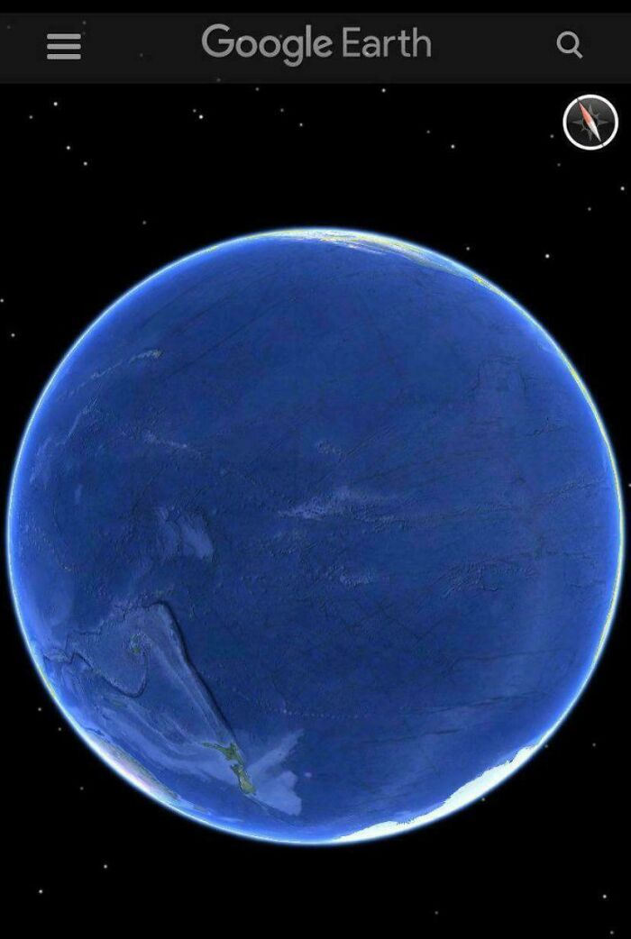 View of Earth’s Pacific Ocean on Google Earth, highlighting vast blue expanse under a dark starry sky.