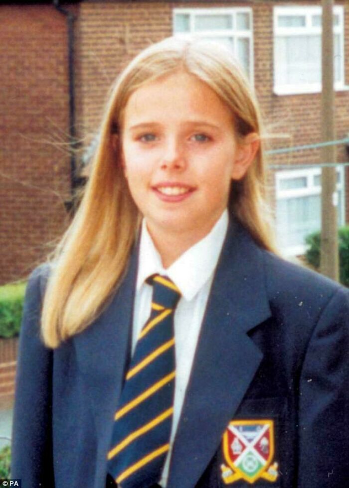 Young girl in school uniform smiling outdoors, representing facts that still remain undiscovered to this day.