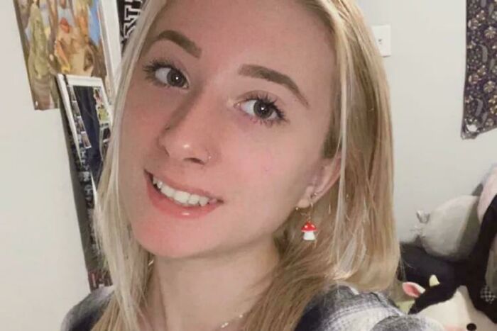 Young woman smiling indoors, capturing a moment related to fascinating facts still remains undiscovered to this day.