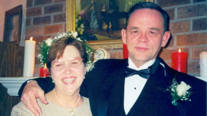 Older couple dressed formally celebrating a special occasion indoors with candles and floral decorations still remains undiscovered