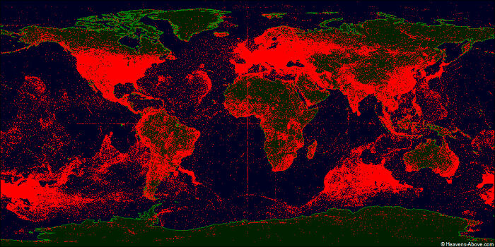 World map showing over 100,000 man-made satellite trajectories in red on a dark backdrop, an informative map perspective.