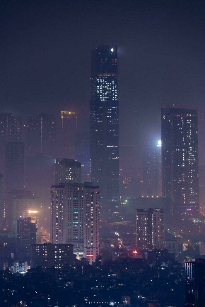 Dense urban skyline at night with illuminated high-rise buildings showing a glimpse of urban hell and societal issues.