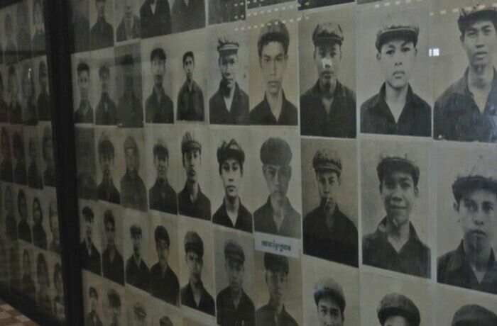 Black and white portraits of young men in uniforms displayed on a wall, part of photos that seem normal until mysteries are revealed.