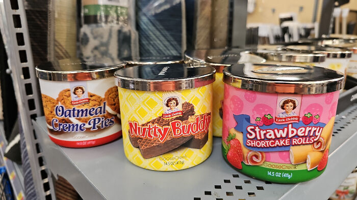 Canned dessert snacks like oatmeal creme pies, nutty buddy, and strawberry shortcake rolls on a store shelf.
