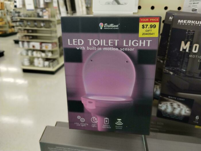 LED toilet light with motion sensor in packaging, displayed in store aisle among other home gadgets for nonsensical things.