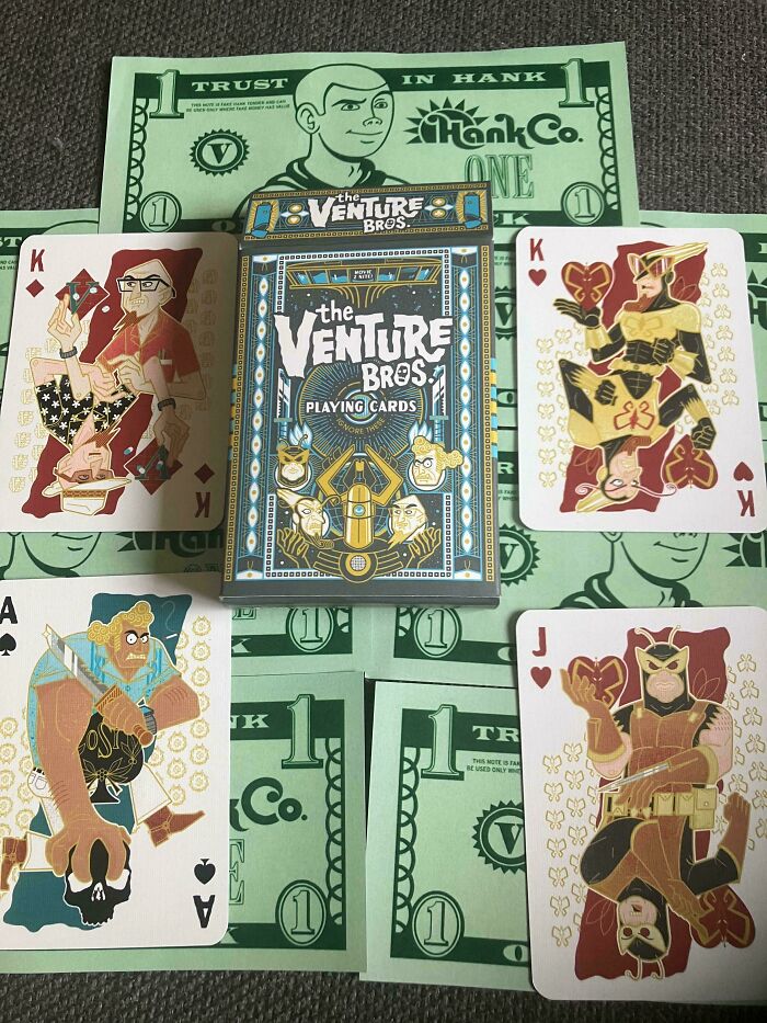 The Venture Bros playing cards displayed on novelty Hank Co money with unique character illustrations.
