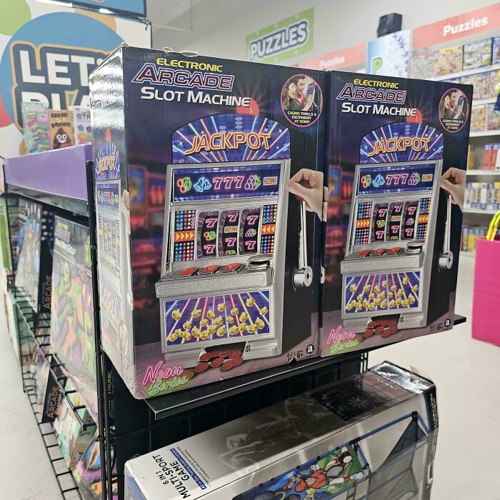 Electronic arcade slot machine toy boxes displayed on store shelves, showcasing a novelty item that actually exists.