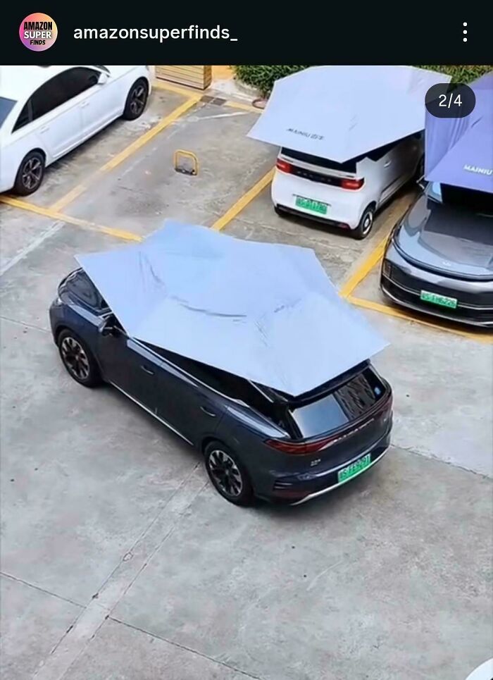 Car umbrella covering multiple parked vehicles, showcasing one of the most nonsensical things that actually exist.