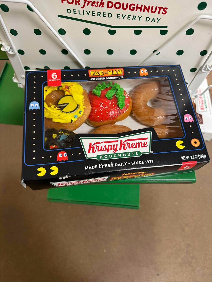 Krispy Kreme Pac-Man themed assorted doughnuts box featuring colorful character designs on doughnuts.