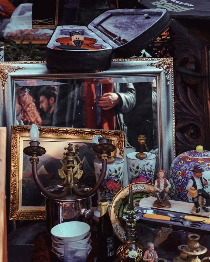 Street photo featuring vintage musical instrument, ornate mirrors, and antique decorative items by Greek photographer Marina Nota.