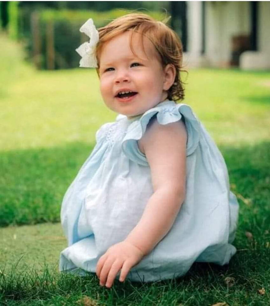 Toddler from Meghan Markle and Prince Harry's kids playing outdoors on grass, enjoying life away from Buckingham Palace.