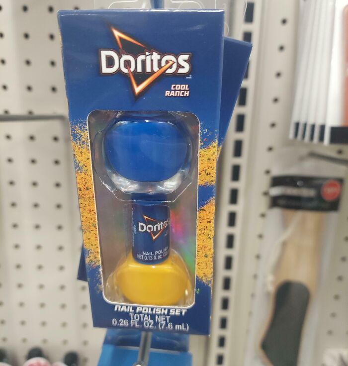 Doritos Cool Ranch nail polish set displayed on store shelf, featuring blue and yellow polish in branded packaging.