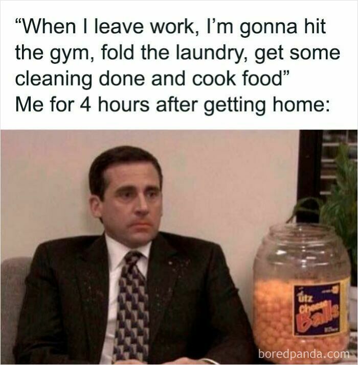 Man in a suit sitting silently next to a large jar of cheese balls, illustrating relatable work memes after hours at home.