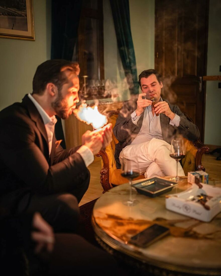 Tristan Tate and other men in a luxurious room, one lighting a cigar, highlighting the legal turmoil shaping Tristan Tate&rsquo;s net worth.