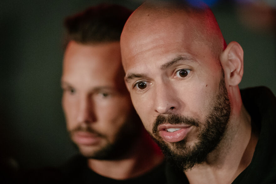 Close-up of Tate brothers with focused expressions, highlighting Tristan Tate amid legal turmoil impacting his net worth in 2025.