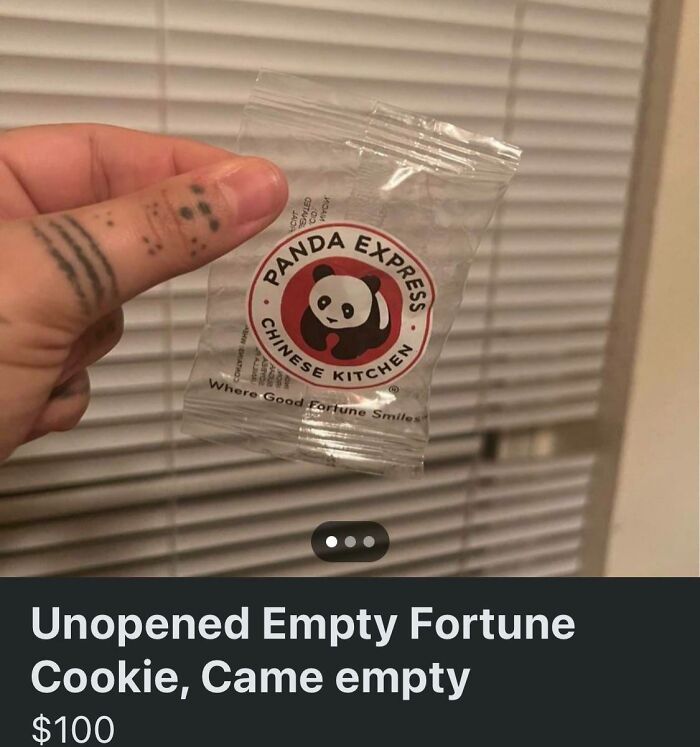 Hand holding unopened empty fortune cookie plastic bag, an unhinged thing people thought they could sell online.