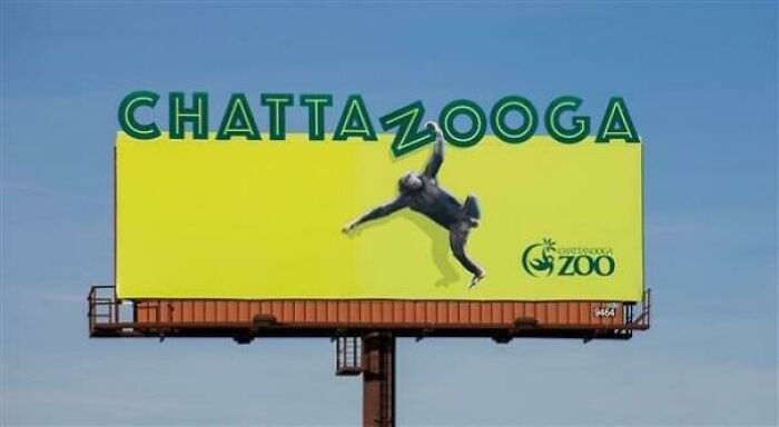 Funny and weird billboard for Chattanooga Zoo with a gorilla integrated into the sign’s text design on a bright yellow background.
