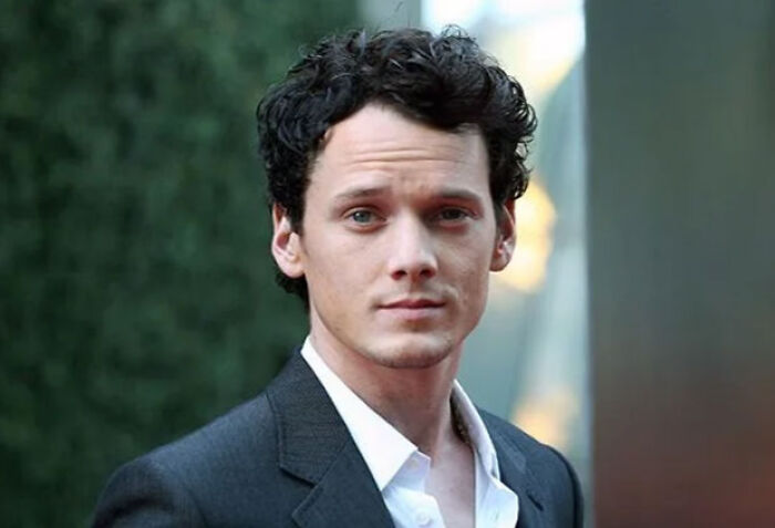 Young male actor in a suit looking at the camera, representing child stars who passed away at tragically young ages.