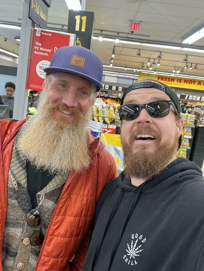 Two bearded men in casual clothes taking a selfie in a store, part of Johnny Derp celebrity look-alike moments.