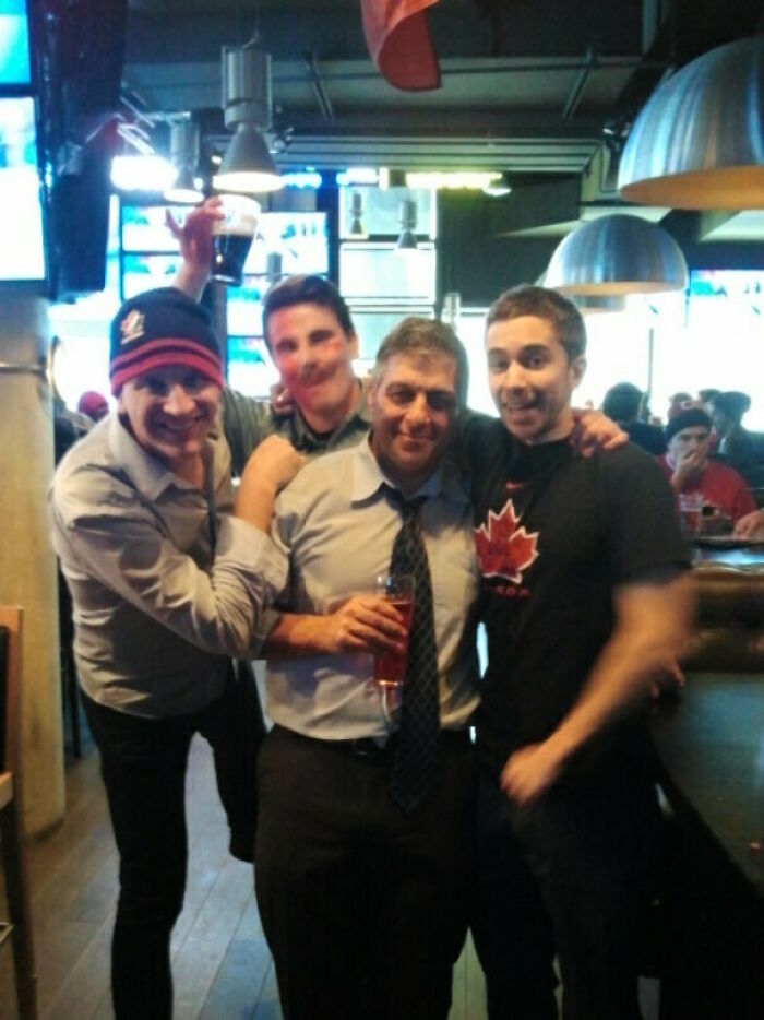 Group of men posing with a blurry figure rumored to be Johnny Derp, popular in celebrity photo fails online.