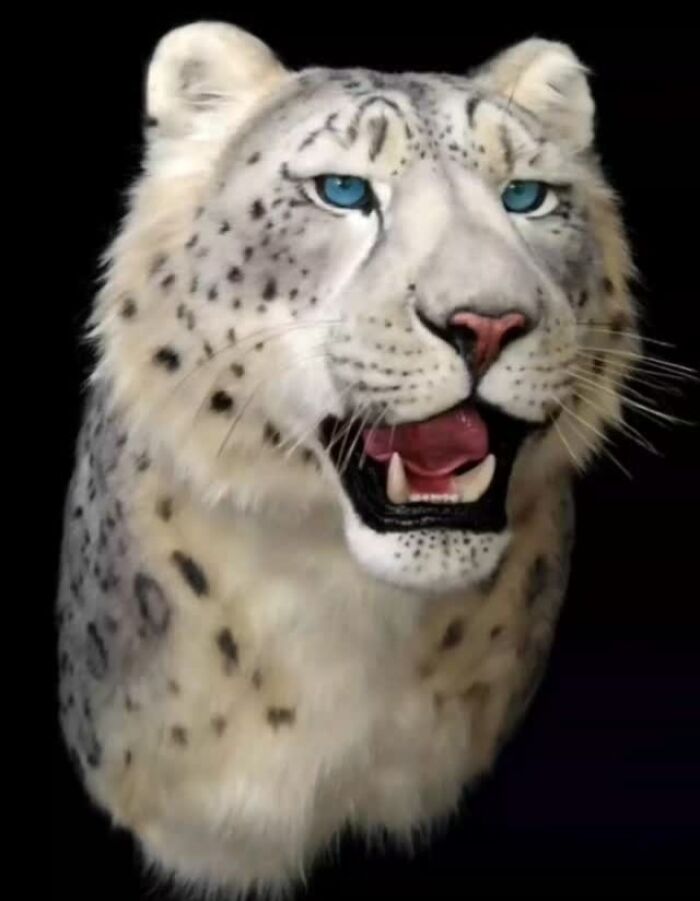 Realistic animal sculpture of a snow leopard crafted with synthetic materials without harming wildlife.
