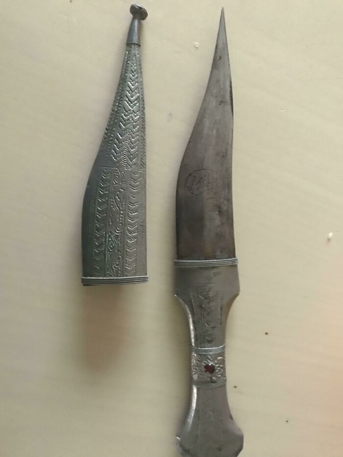 Vintage ornate dagger with engraved metal sheath, an example of old items people found but had no clue about.