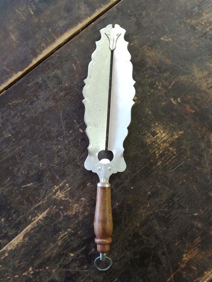 Old vintage kitchen tool with wooden handle and metal blade, an unusual find with no clear use in the internet mystery collection.