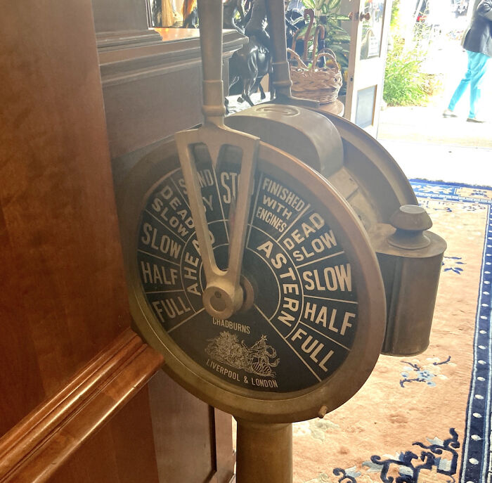 Vintage ship engine order telegraph in wooden interior, an old find with no clue but internet help for identification.