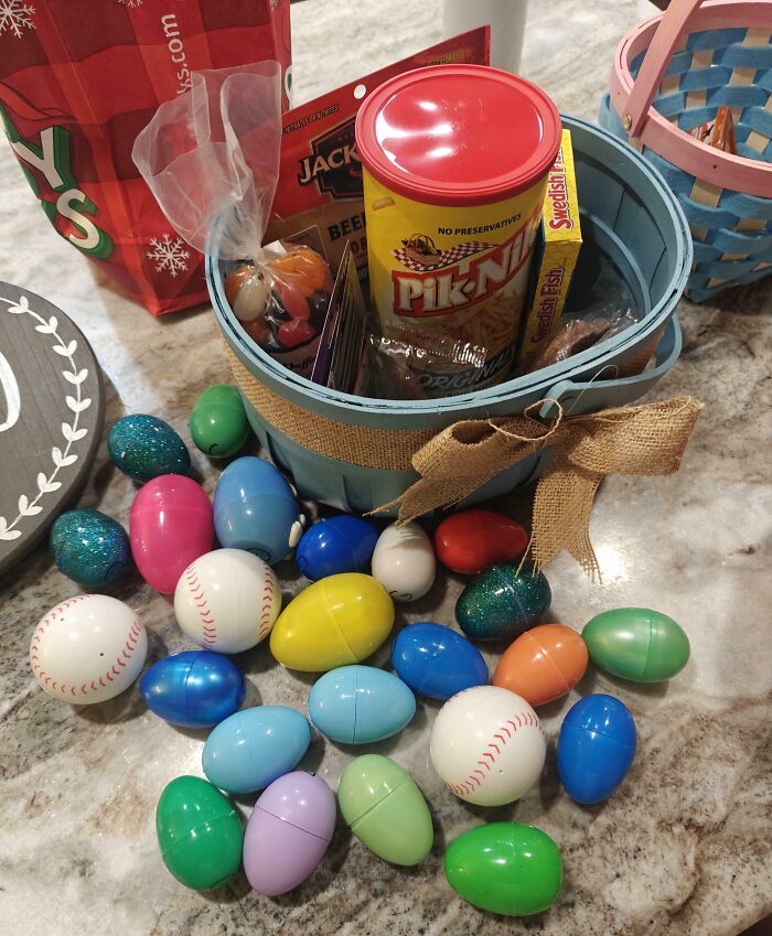 Easter basket filled with snacks and colorful plastic eggs, showcasing funny and wholesome parent moments shared by kids