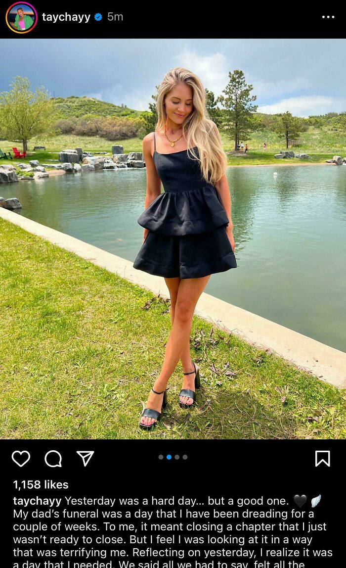 Woman in black dress standing by a scenic lake, representing the theme of take your baby to the gym fitness influencers.
