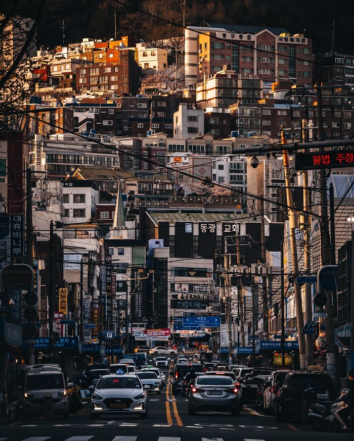 Busy urban street in Asia with traffic and densely packed buildings showcasing everyday life scenes.