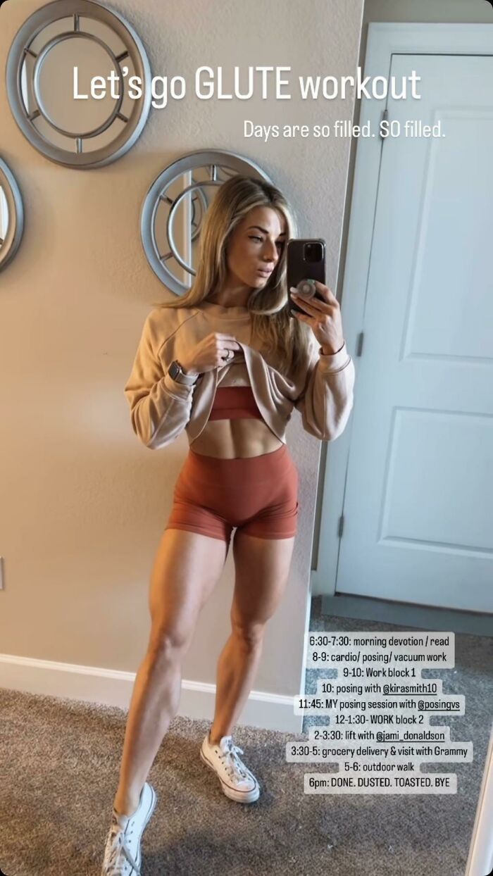 Woman taking a gym mirror selfie showing toned abs and legs, highlighting fitness influencers and workout routines.
