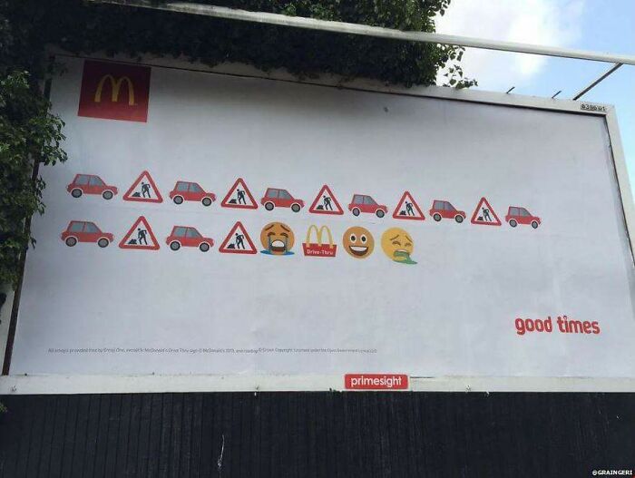Billboard using emojis and symbols to humorously depict traffic with McDonald's drive-thru, part of funny and weird billboards.