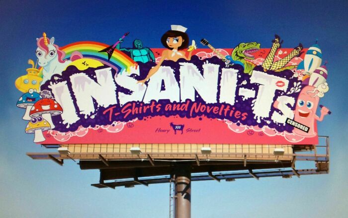 Colorful funny billboard for Insani-T T-Shirts and Novelties featuring playful cartoon characters and vibrant designs.
