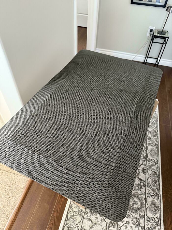 Gray mat floating in midair above a carpeted floor, an unphotoshopped pic that looks fake but is 100% real.