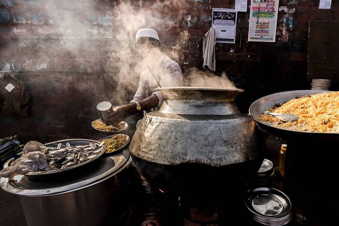 Street food vendor serving steaming traditional dishes, capturing everyday life in India with authentic local flavors.