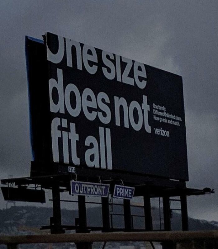 Funny and weird billboard with bold text stating one size does not fit all, showcasing creative advertising outdoors.