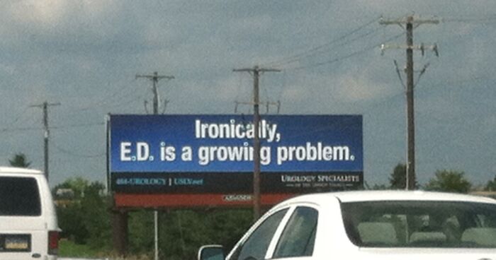 Funny and weird billboard with a humorous message about a growing problem, visible from a busy roadside.